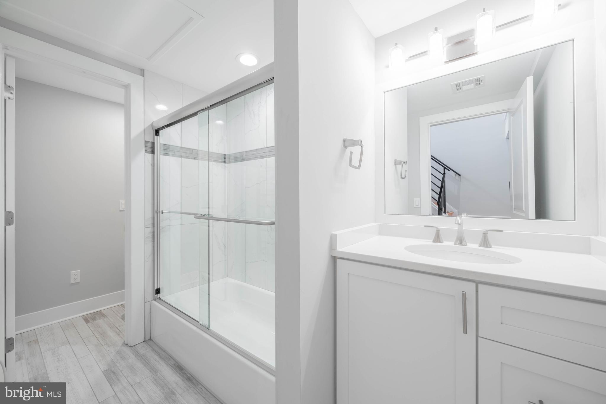 317 North Front Street Philadelphia, PA 19106 - Photo 17 of 27 a bathroom with a shower sink and mirror