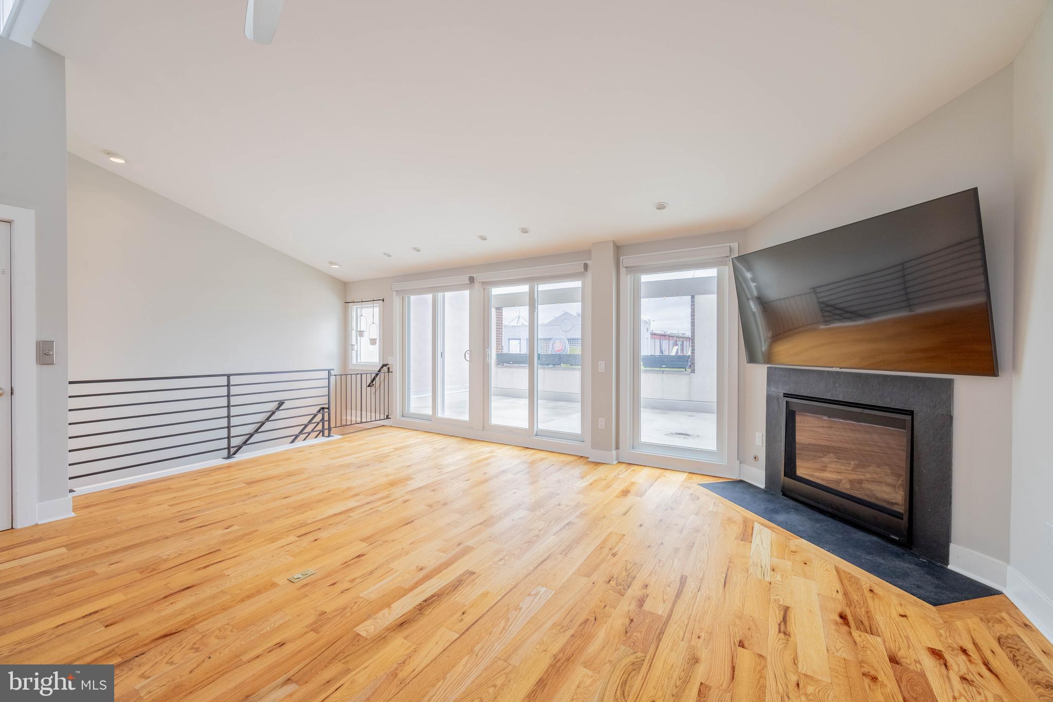 317 North Front Street Philadelphia, PA 19106 - Photo 2 of 27 a view of an empty room with wooden floor fireplace and a window