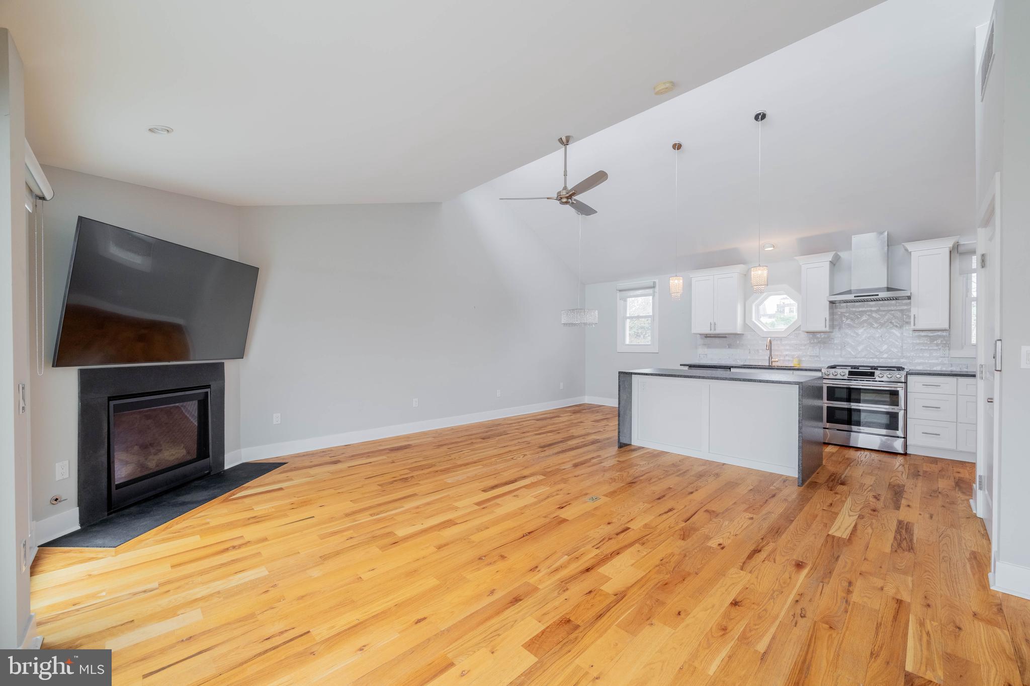 317 North Front Street Philadelphia, PA 19106 - Photo 3 of 27 a kitchen with granite countertop a stove a sink and a microwave