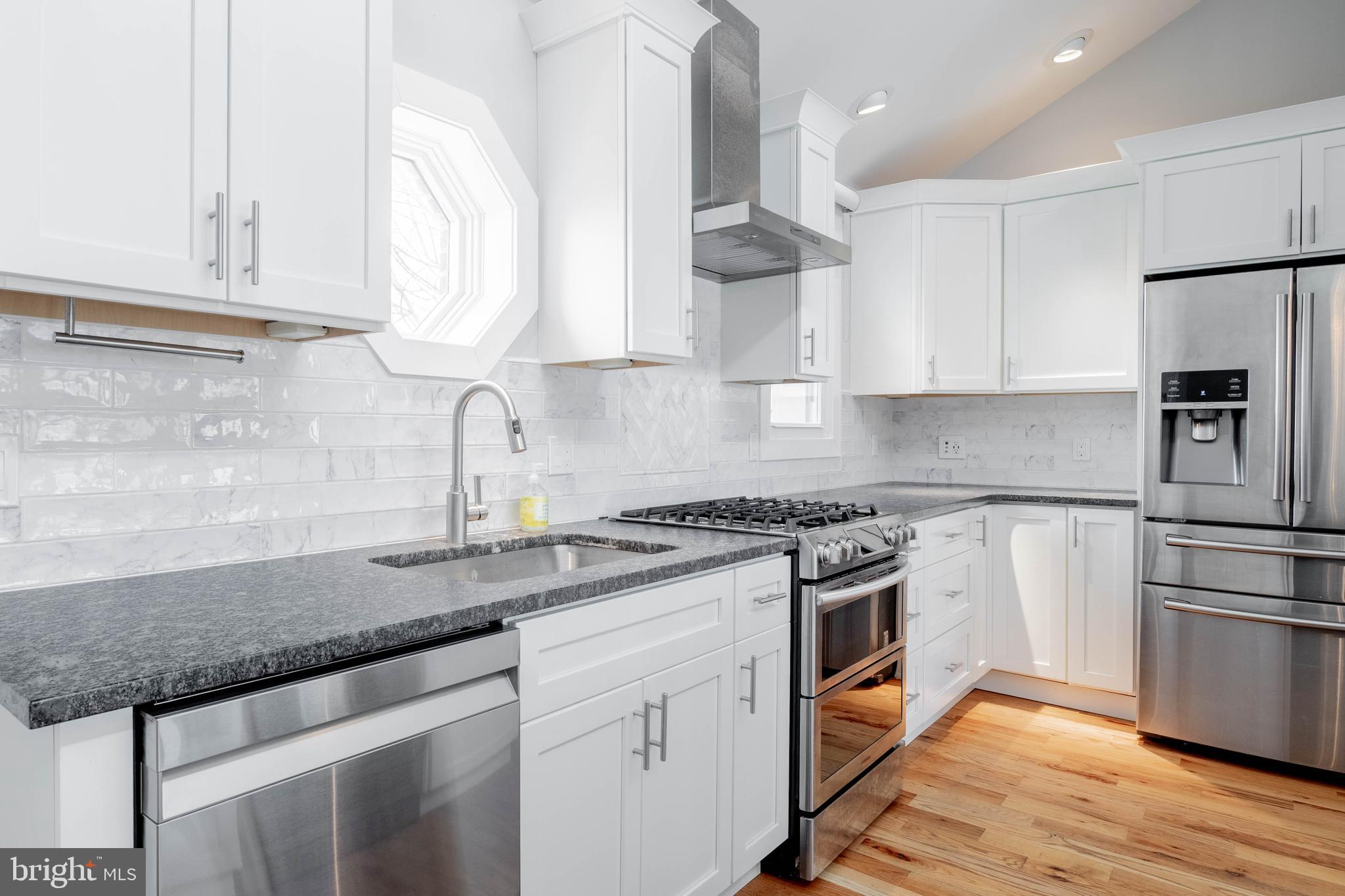 317 North Front Street Philadelphia, PA 19106 - Photo 5 of 27 a kitchen with granite countertop a sink stainless steel appliances and cabinets