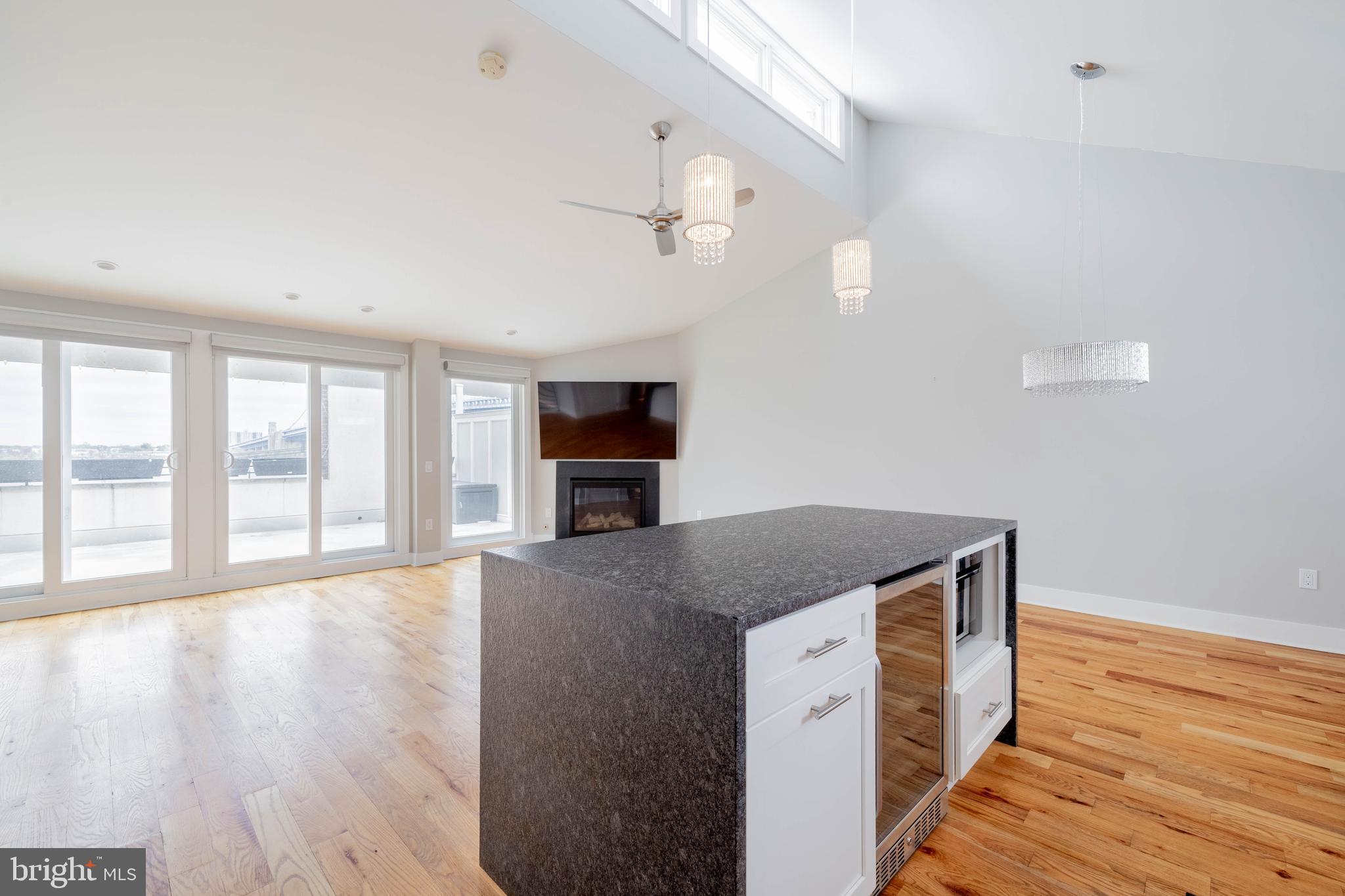 317 North Front Street Philadelphia, PA 19106 - Photo 6 of 27 a hall with kitchen island a stove wooden floors and a view of living room