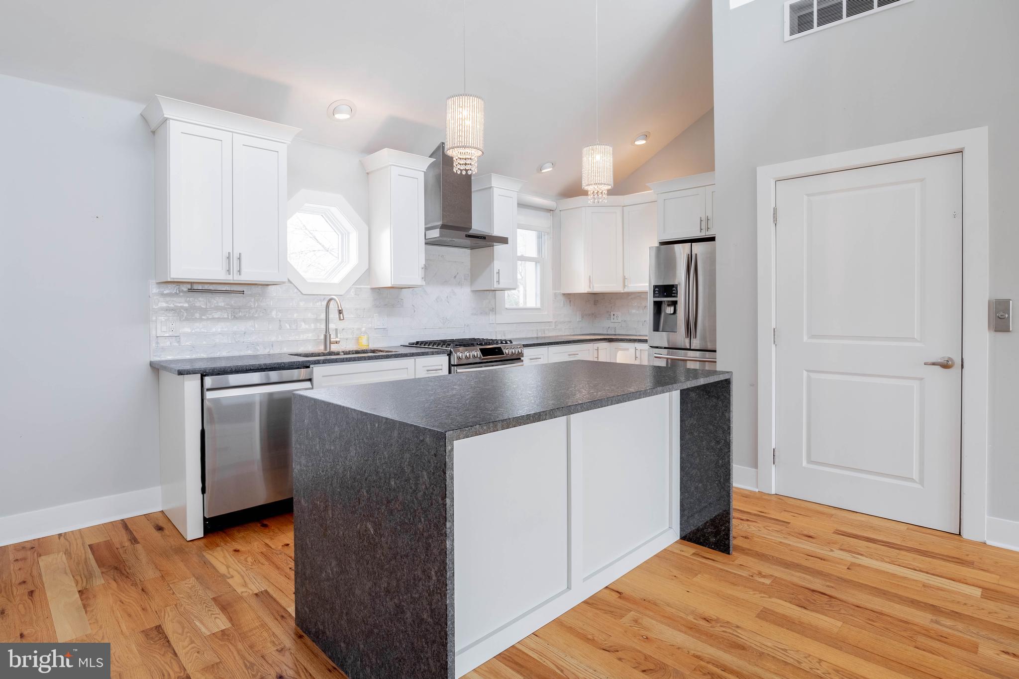 317 North Front Street Philadelphia, PA 19106 - Photo 7 of 27 a kitchen with kitchen island granite countertop a sink and a stove