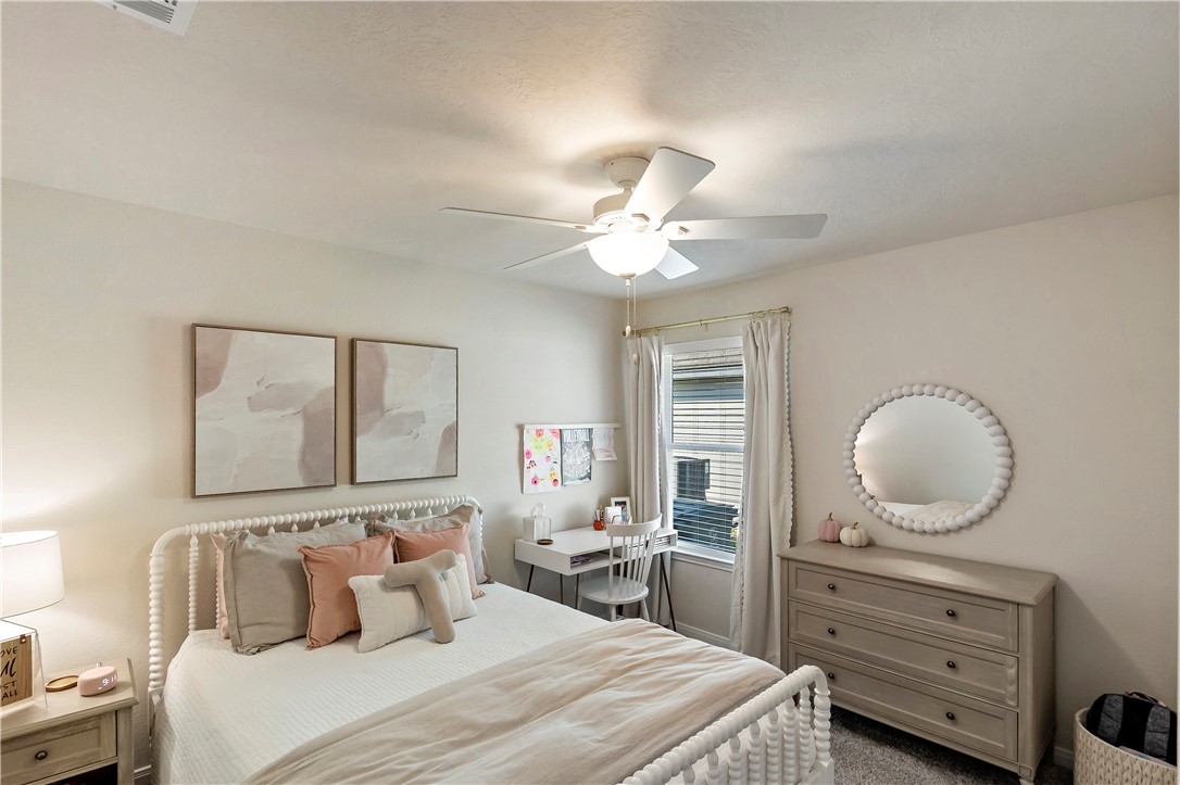 1310 Kingsgate Drive Bryan, TX 77807 - Photo 18 of 24 Bedroom featuring a ceiling fan and dark carpet