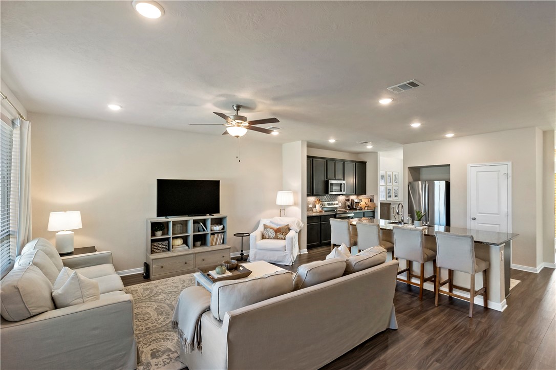 1310 Kingsgate Drive Bryan, TX 77807 - Photo 5 of 24 Living room featuring dark wood-type flooring, a ceiling fan, and recessed lighting