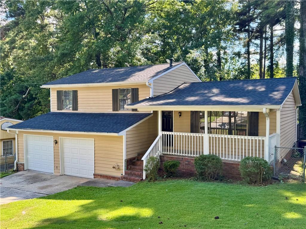 a front view of a house with a garden and yard