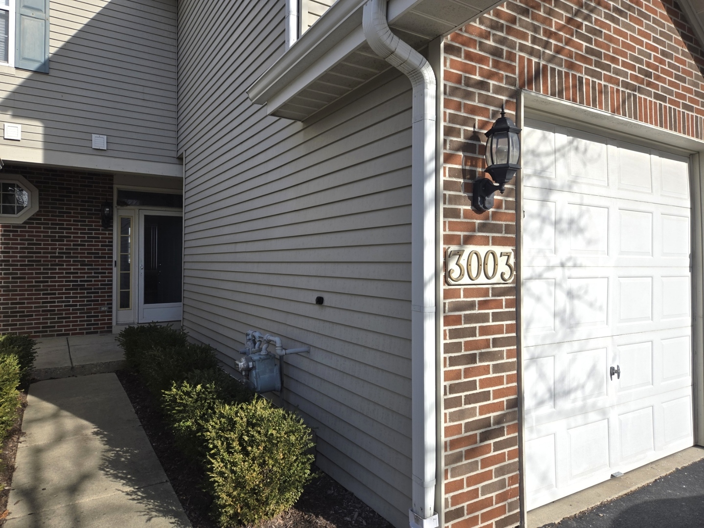 3003 Anton Drive Aurora, IL 60504 - Photo 2 of 10 a view of a house with a door and wooden bench