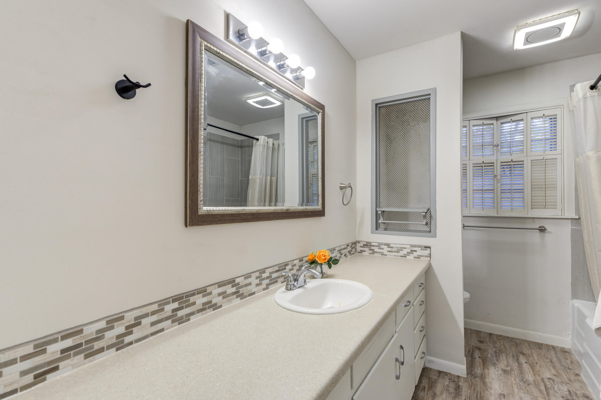 3614 45th Street Lubbock, TX 79413 - Photo 11 of 38 a bathroom with a sink and a mirror
