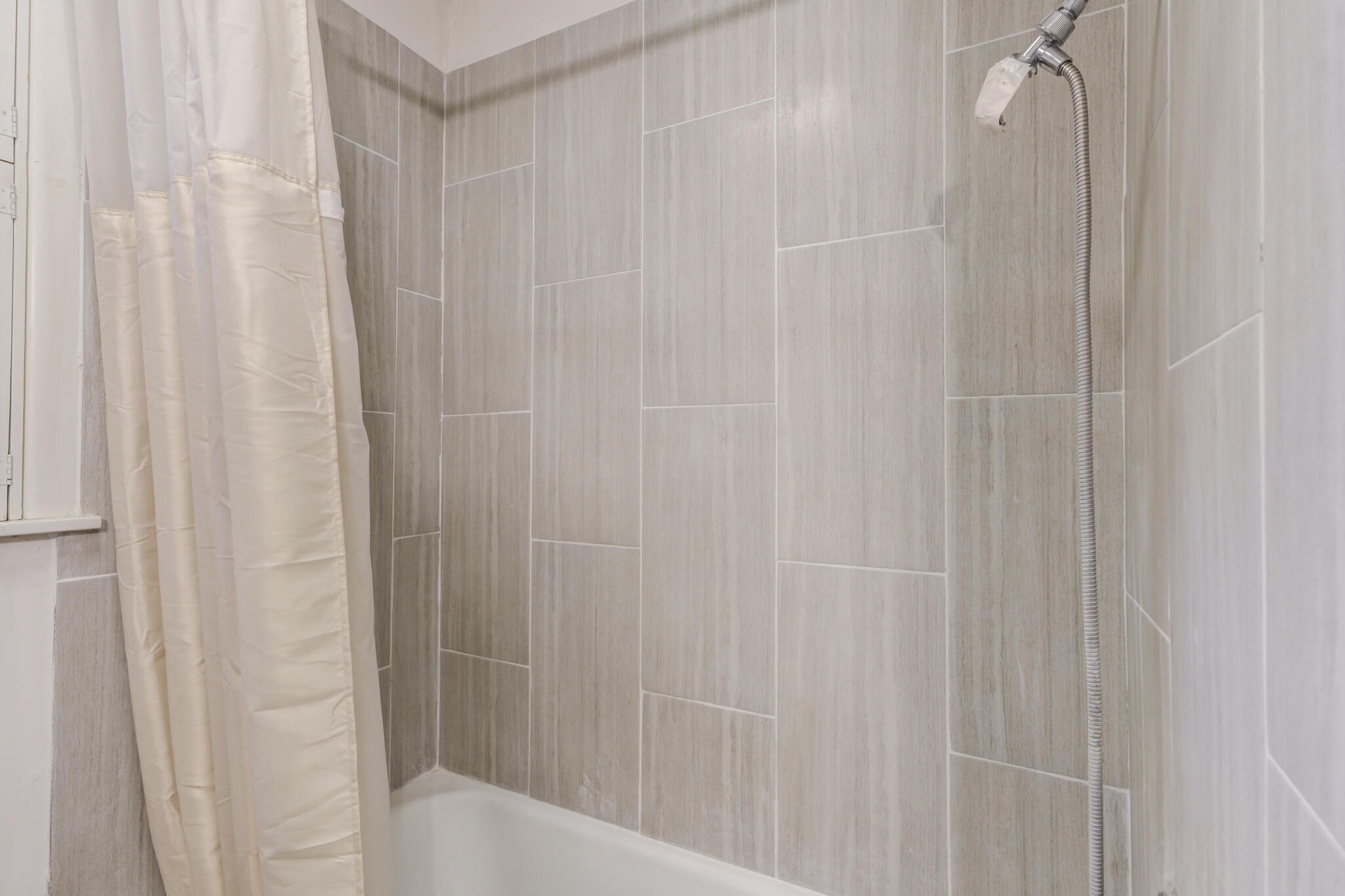 3614 45th Street Lubbock, TX 79413 - Photo 13 of 38 a bathroom with a shower and a curtain