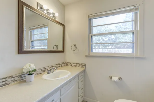 a view of an empty room with a fireplace and a window