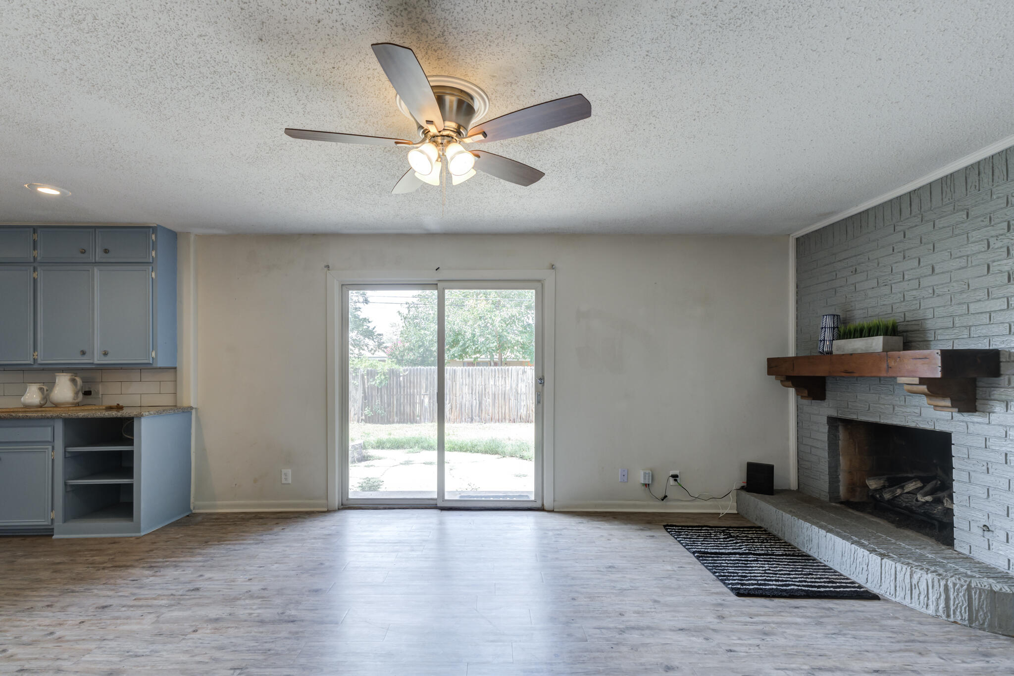 3614 45th Street Lubbock, TX 79413 - Photo 19 of 38 a view of an empty room with a fireplace and a window
