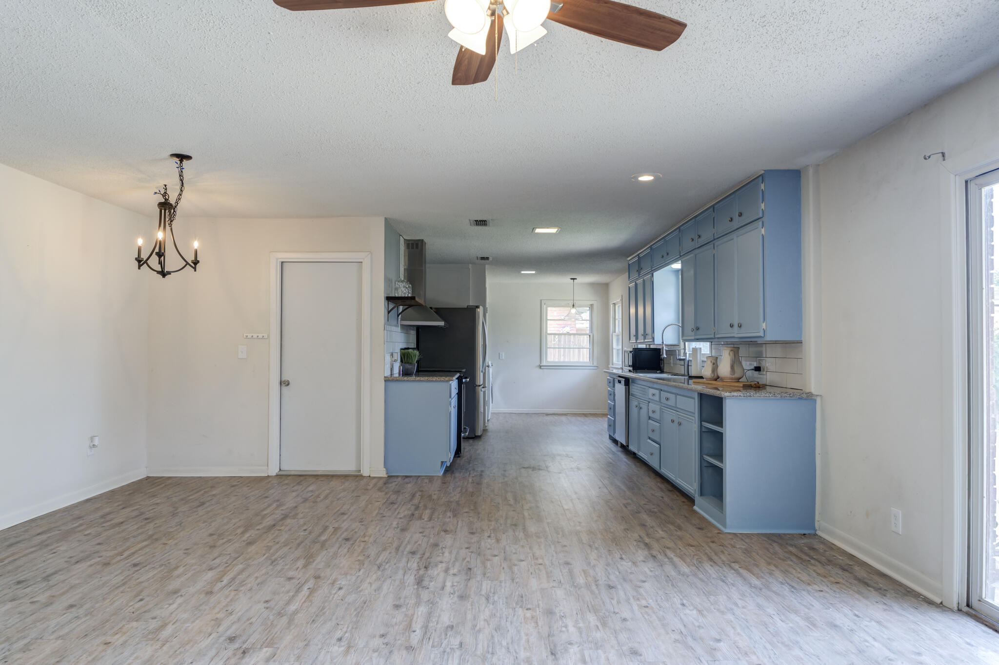 3614 45th Street Lubbock, TX 79413 - Photo 21 of 38 a large kitchen with a refrigerator and a stove top oven