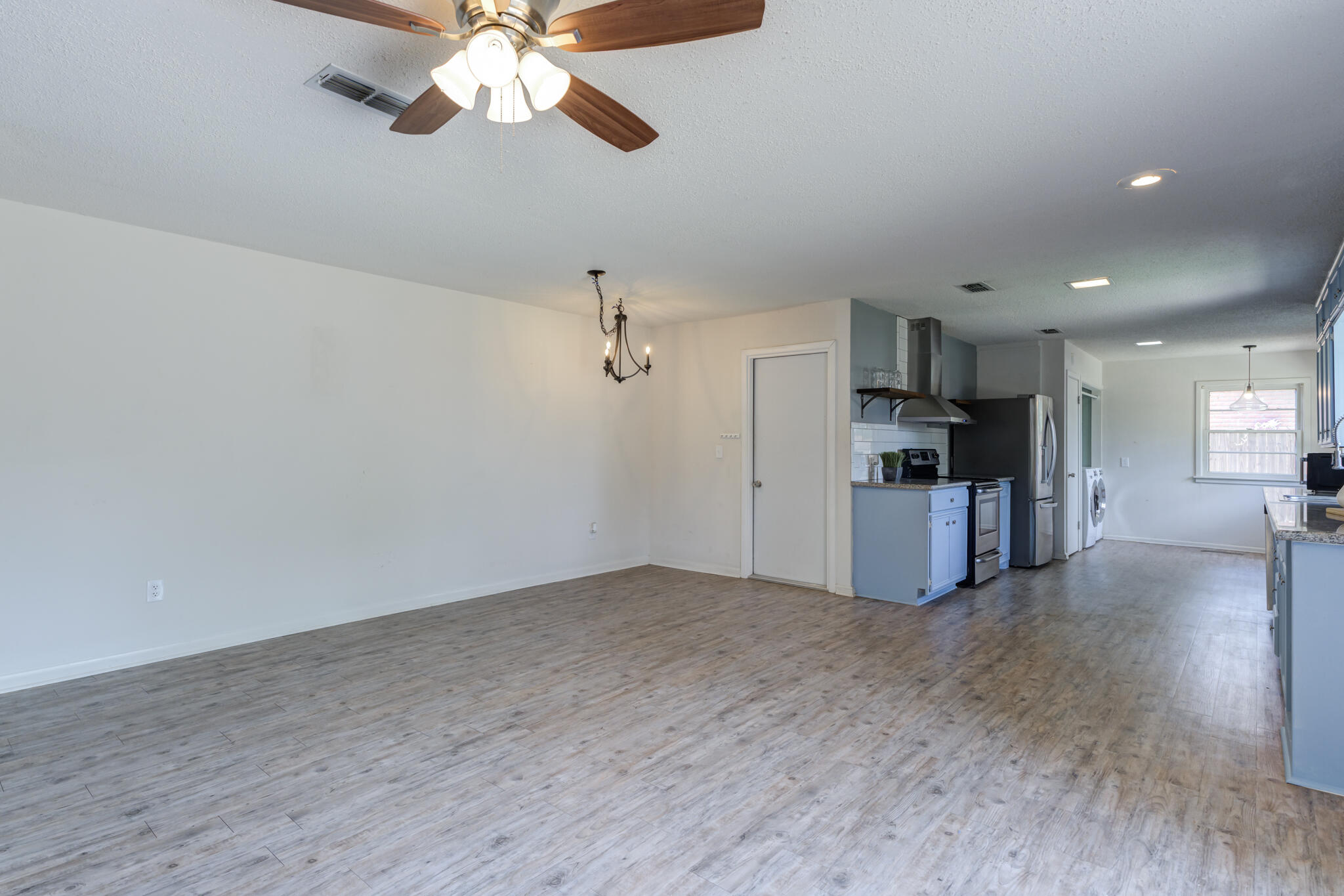 3614 45th Street Lubbock, TX 79413 - Photo 22 of 38 a view of empty room with wooden floor and ceiling fan