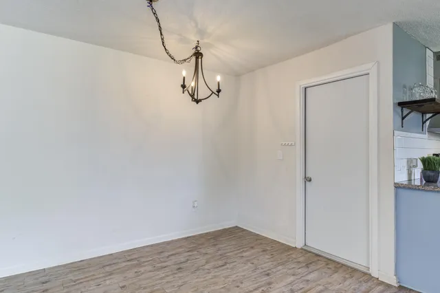a large kitchen with stainless steel appliances lots of counter space and wooden floor