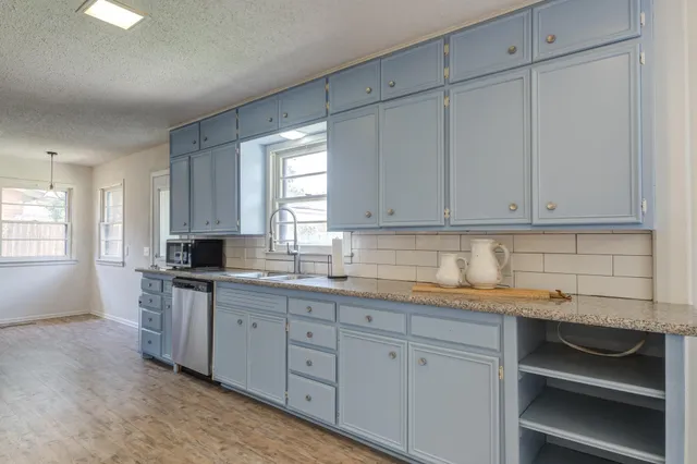 a kitchen with granite countertop stainless steel appliances and counter space