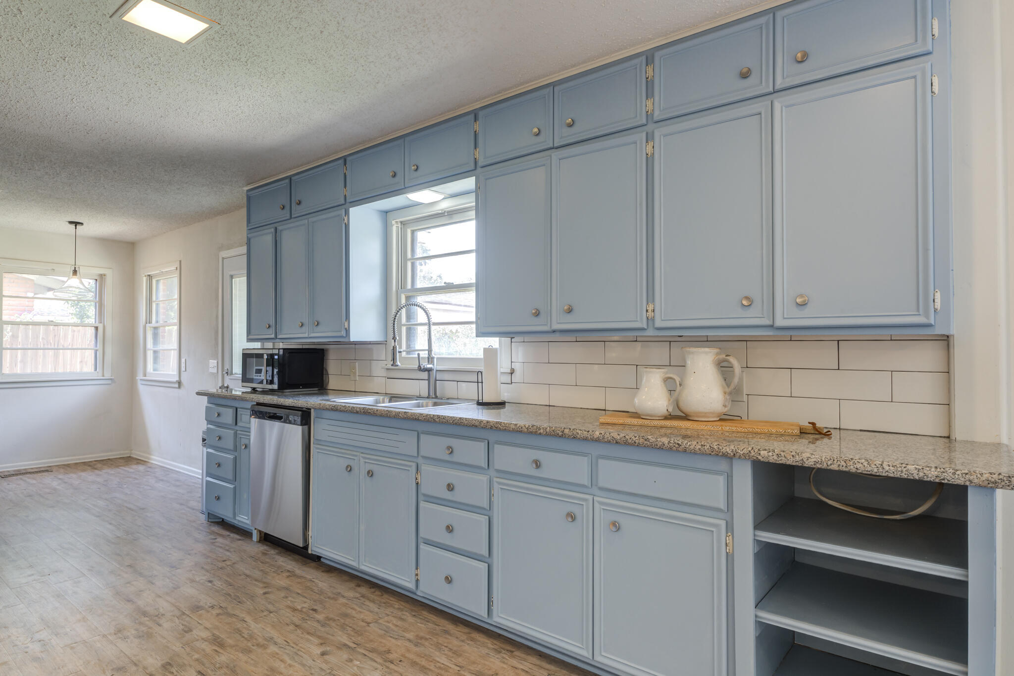 3614 45th Street Lubbock, TX 79413 - Photo 29 of 38 a kitchen with white cabinets and sink