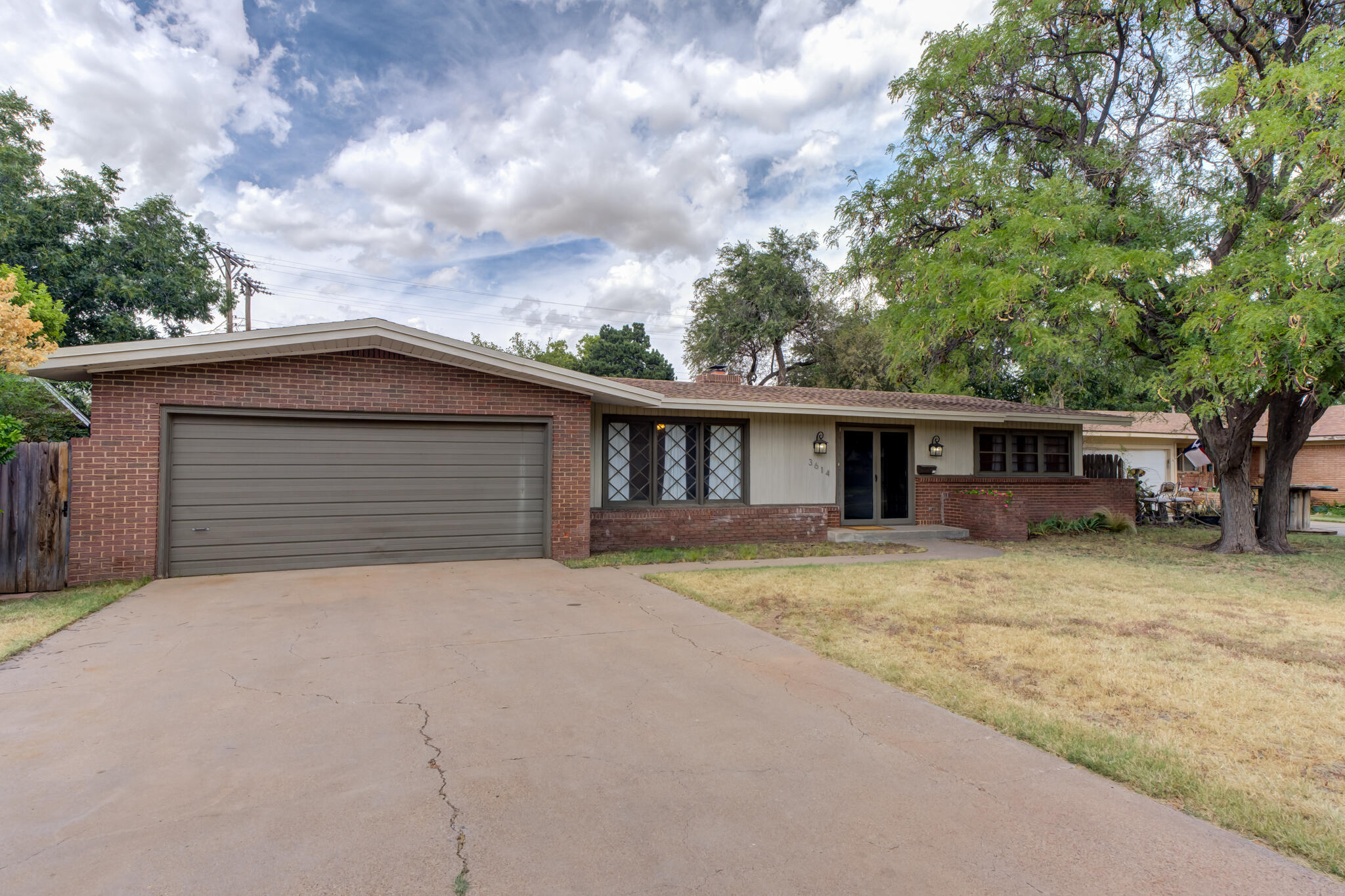 3614 45th Street Lubbock, TX 79413 - Photo 3 of 38 a view of a house with a yard and large tree
