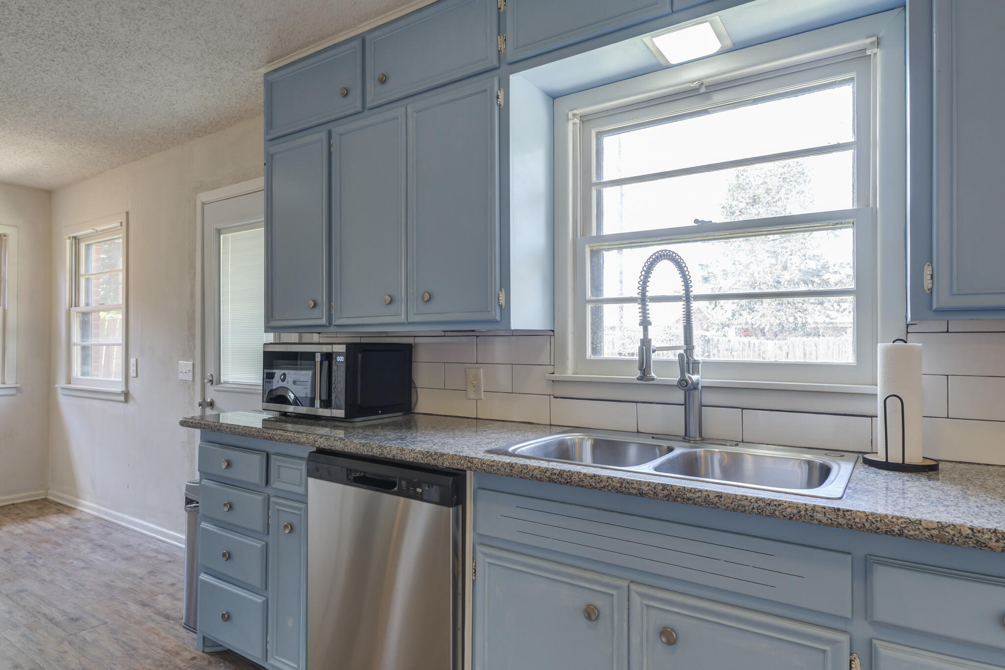 3614 45th Street Lubbock, TX 79413 - Photo 32 of 38 a kitchen with stainless steel appliances granite countertop white cabinets and a window