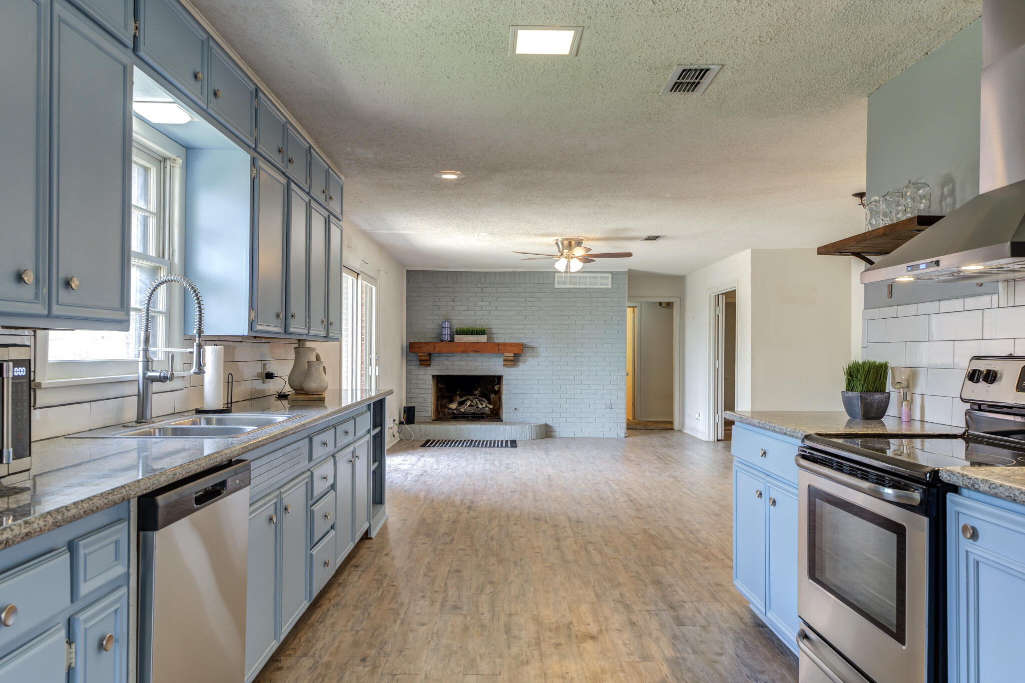 3614 45th Street Lubbock, TX 79413 - Photo 35 of 38 a kitchen with stainless steel appliances granite countertop a stove and a sink