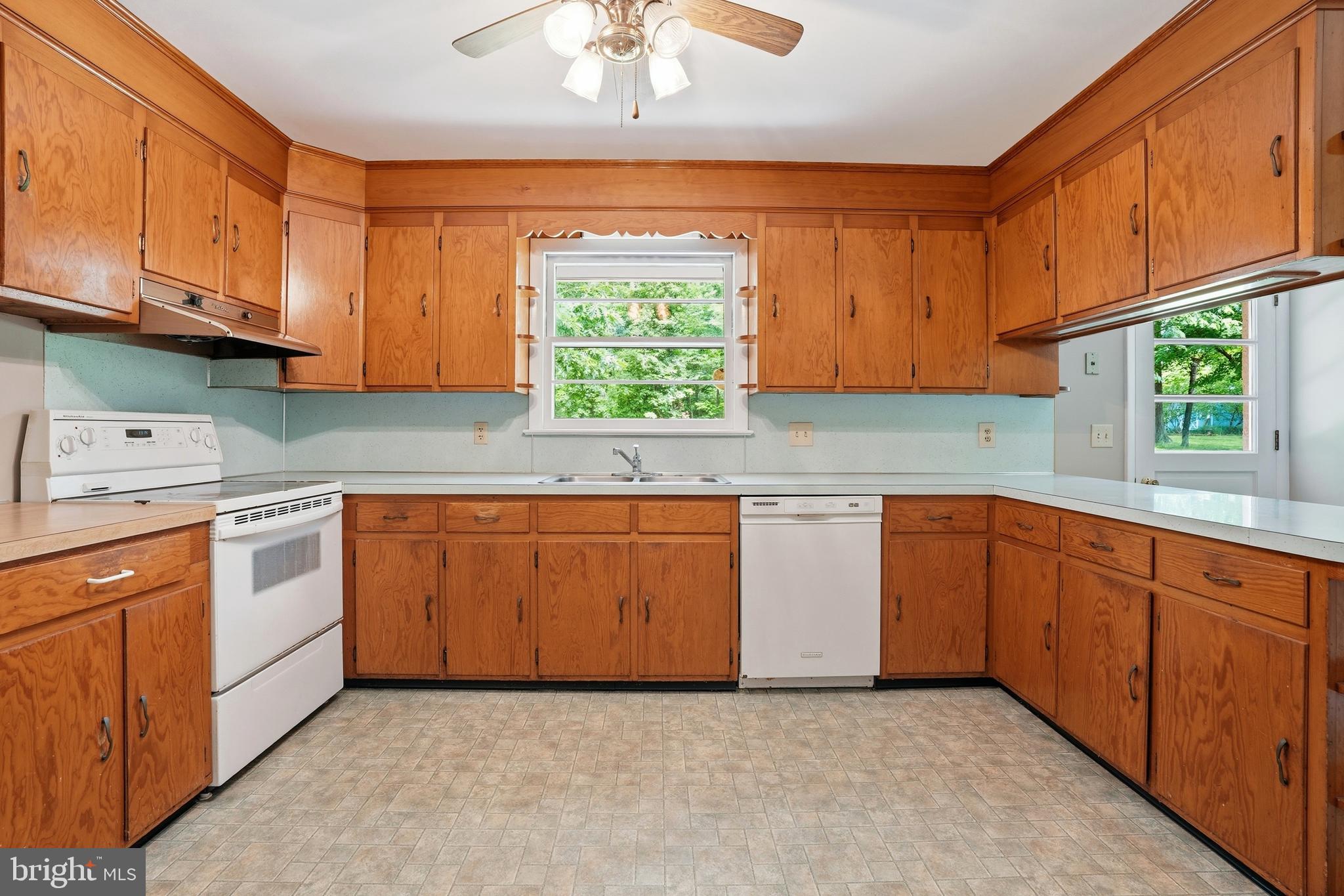 486 Derstine Road Hatfield, PA 19440 - Photo 14 of 53 a kitchen with granite countertop a sink cabinets stainless steel appliances and a window