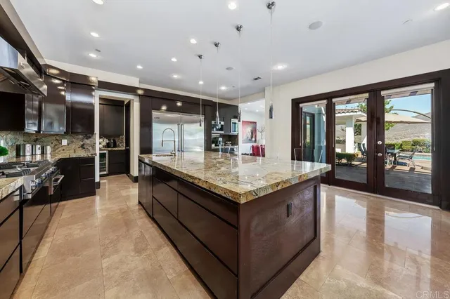 a kitchen with granite countertop counter top space a sink stainless steel appliances and cabinets
