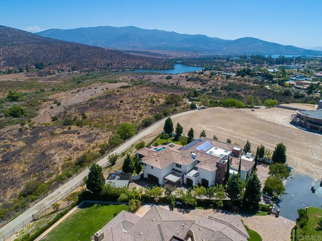 an aerial view of residential house and sandy dunes