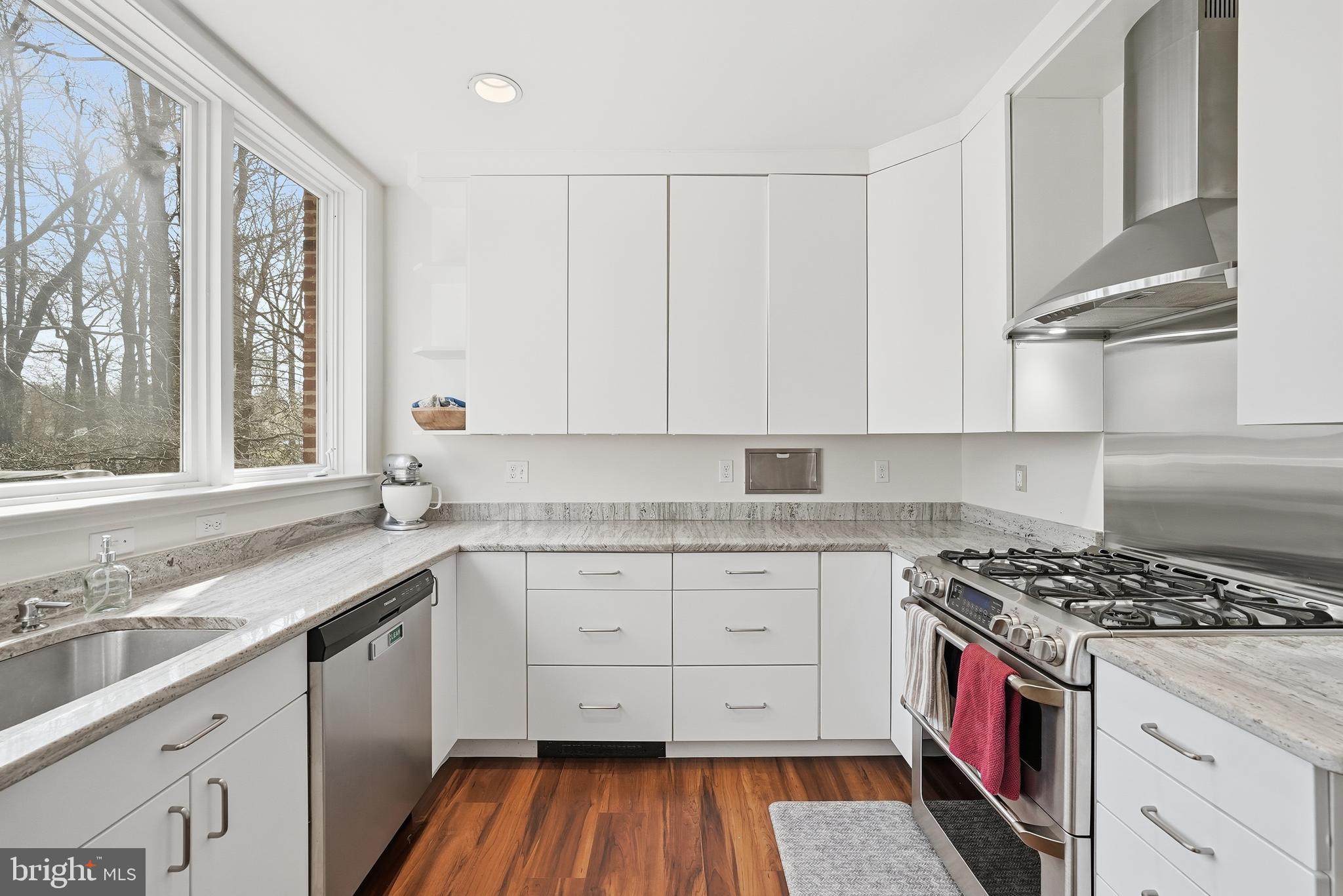 4938 Quebec Street Northwest Washington, DC 20016 - Photo 13 of 51 a kitchen with a sink stove and cabinets