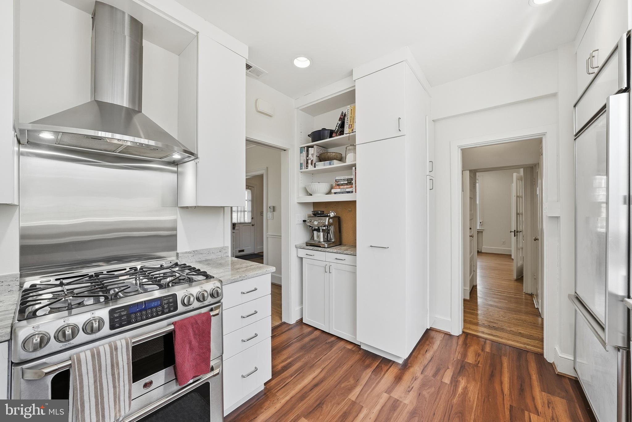 4938 Quebec Street Northwest Washington, DC 20016 - Photo 15 of 51 a kitchen with a stove and a refrigerator