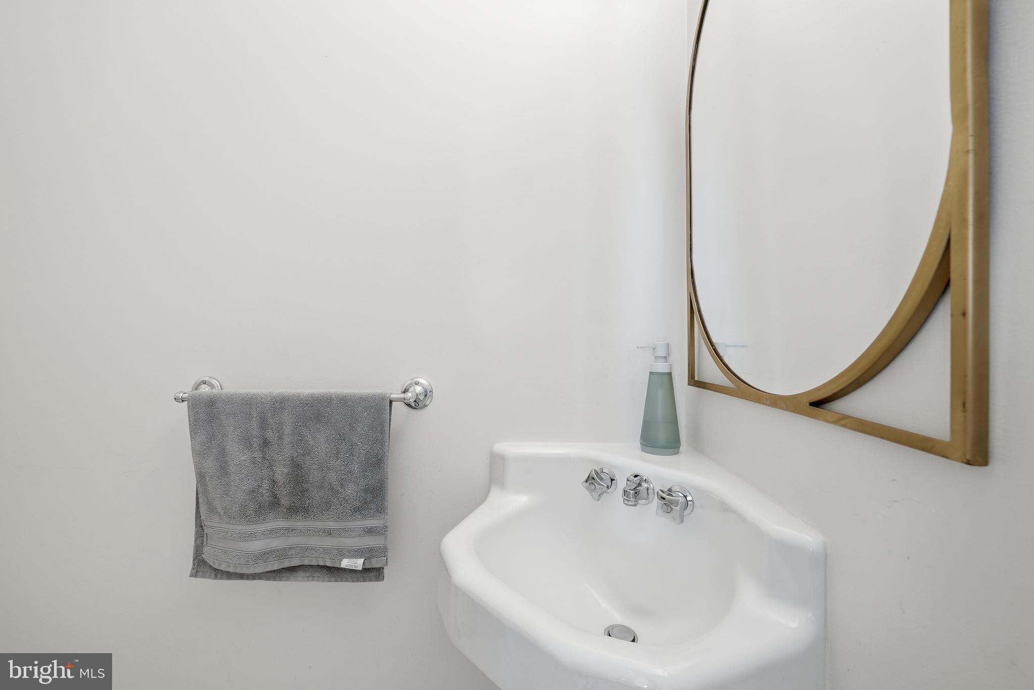 4938 Quebec Street Northwest Washington, DC 20016 - Photo 20 of 51 a bathroom with a sink and a mirror