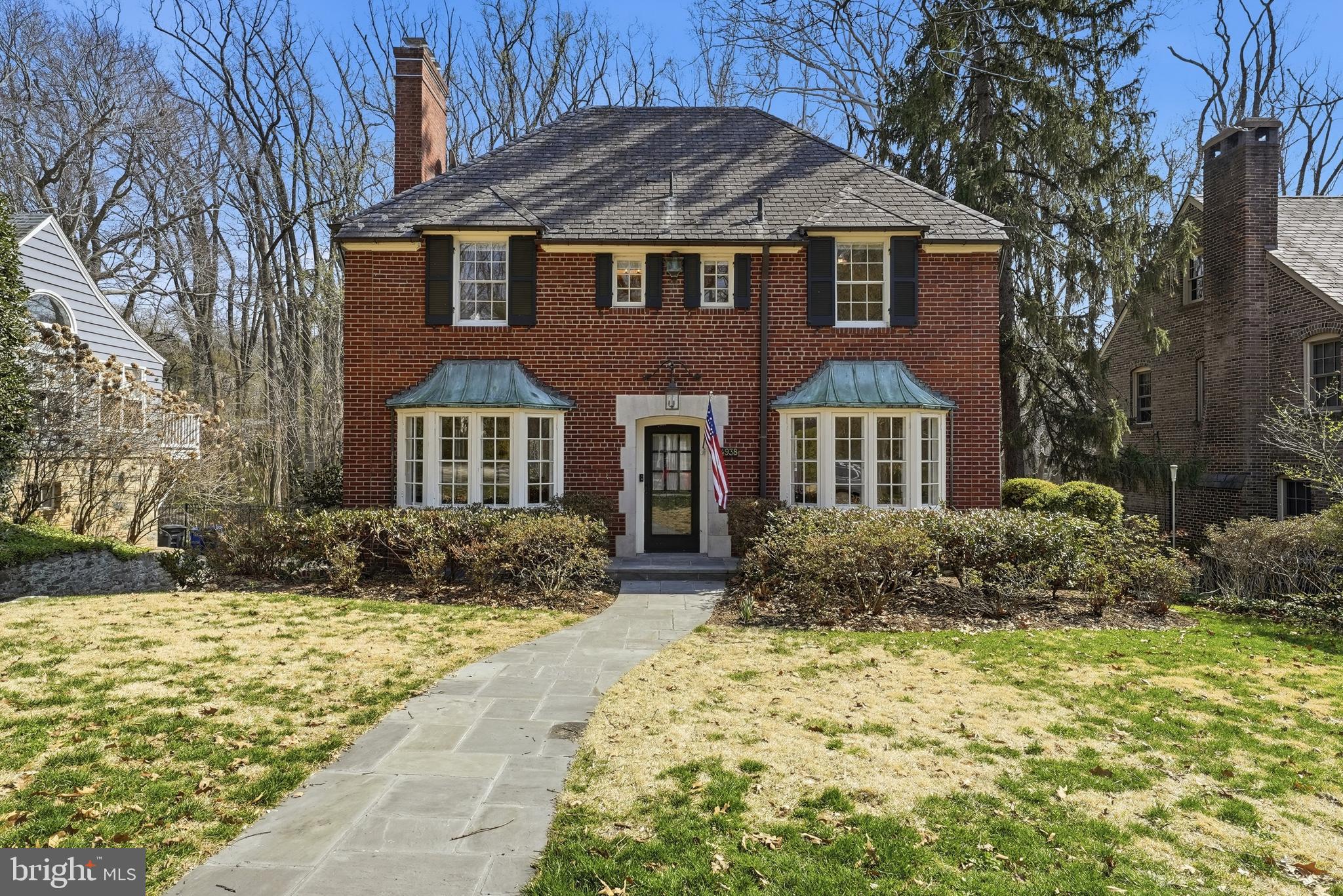 4938 Quebec Street Northwest Washington, DC 20016 - Photo 2 of 51 a front view of a house with garden