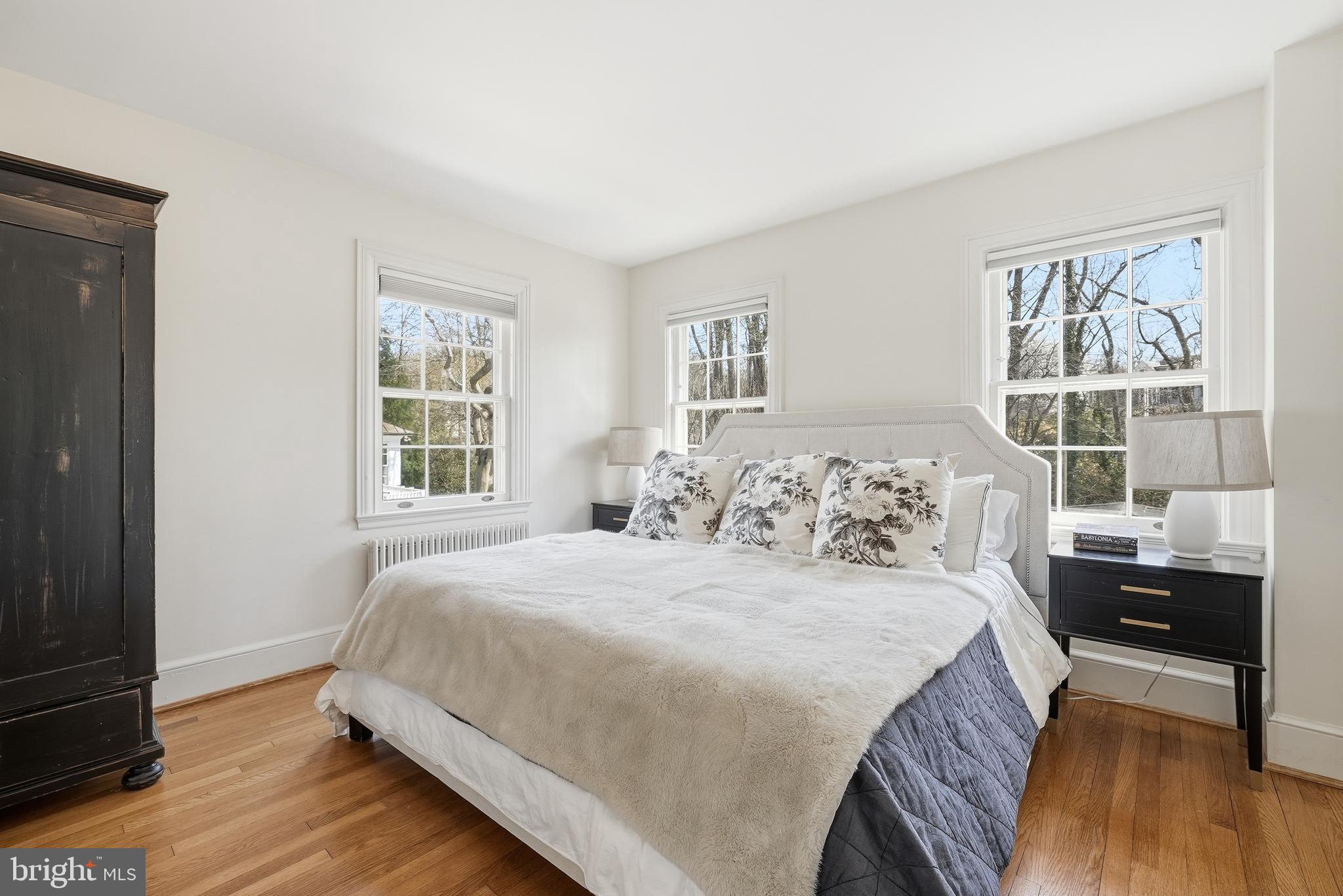 4938 Quebec Street Northwest Washington, DC 20016 - Photo 22 of 51 a bedroom with a bed and wooden floor