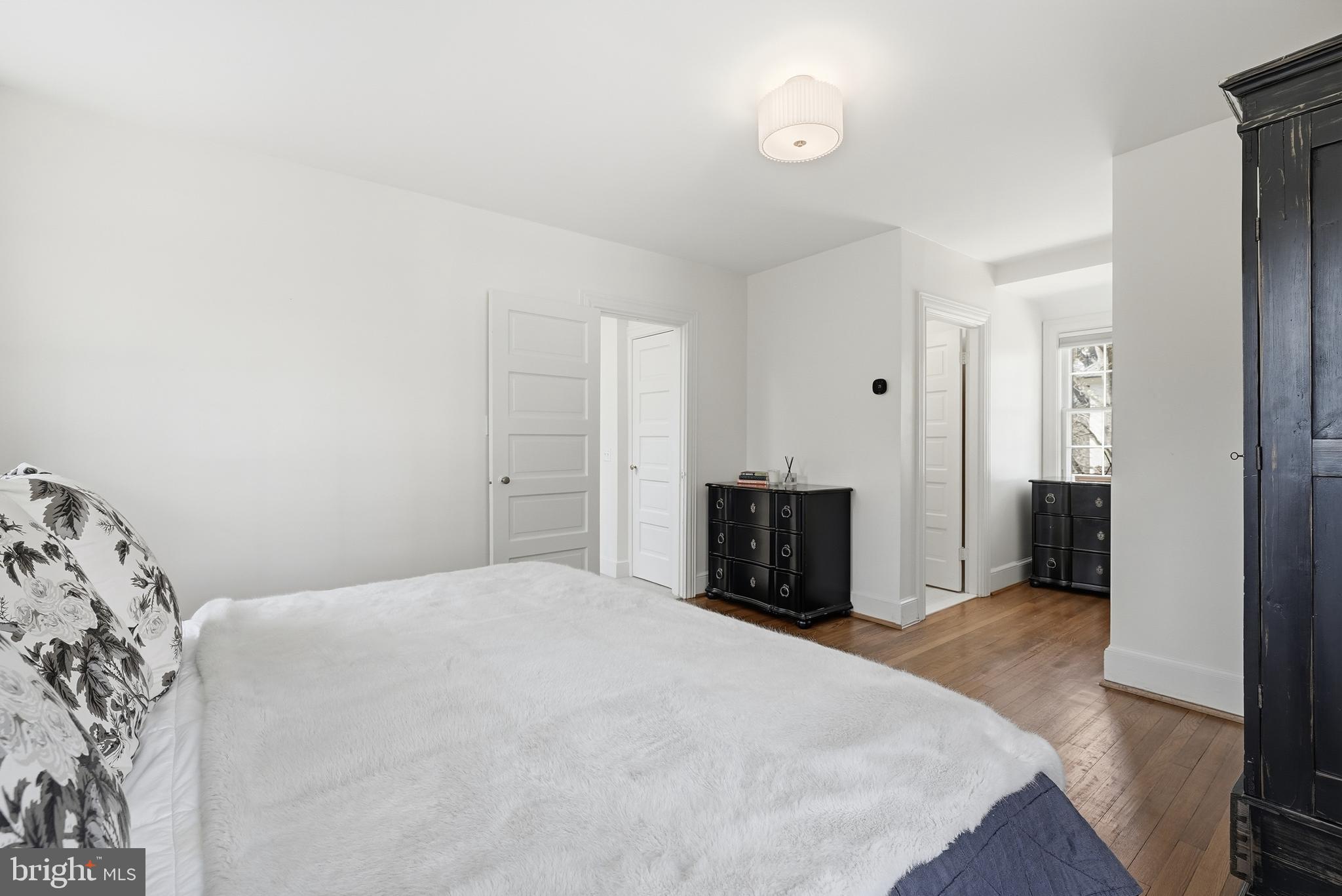 4938 Quebec Street Northwest Washington, DC 20016 - Photo 24 of 51 a bedroom with a bed and a window