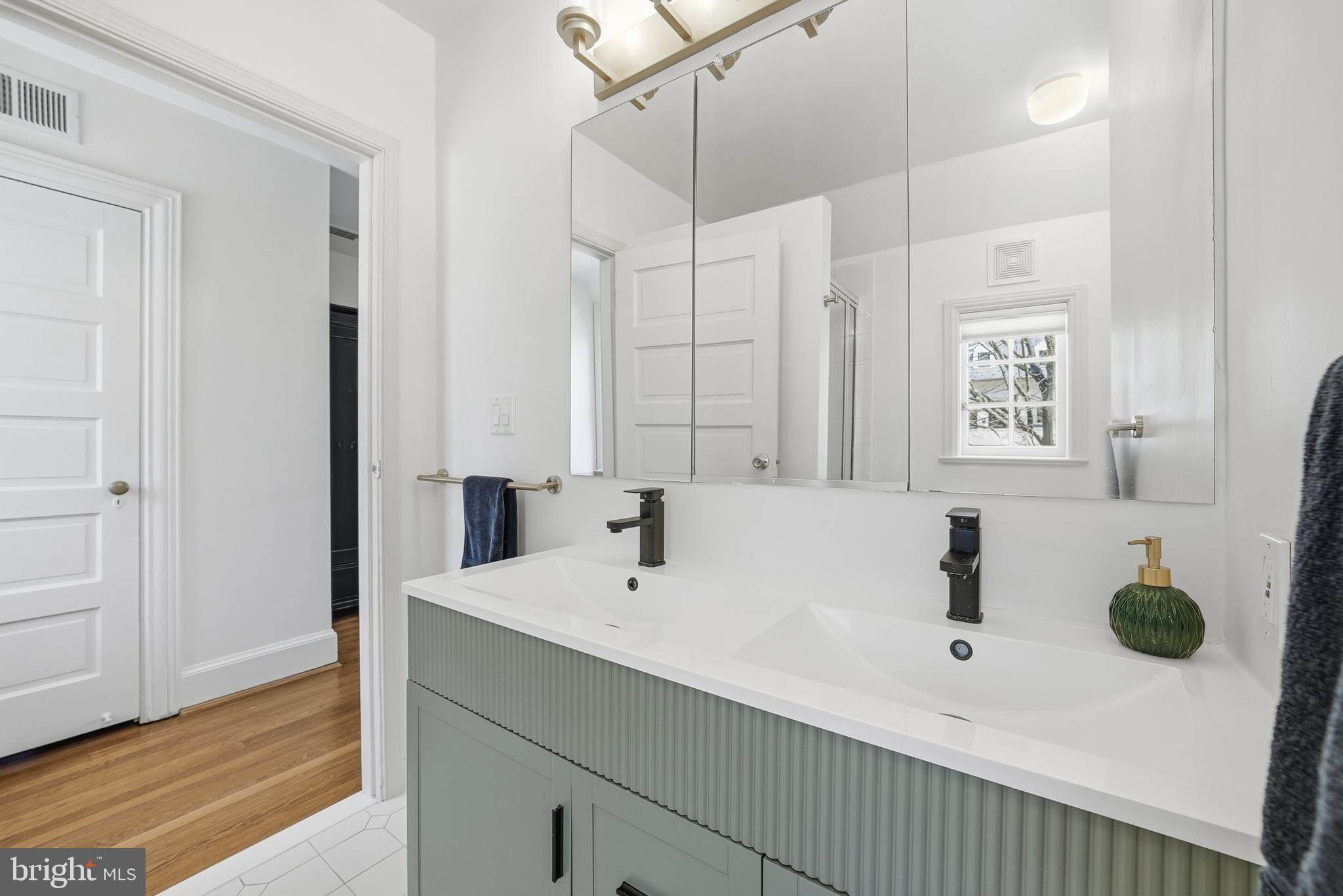 4938 Quebec Street Northwest Washington, DC 20016 - Photo 26 of 51 a bathroom with a sink and a mirror