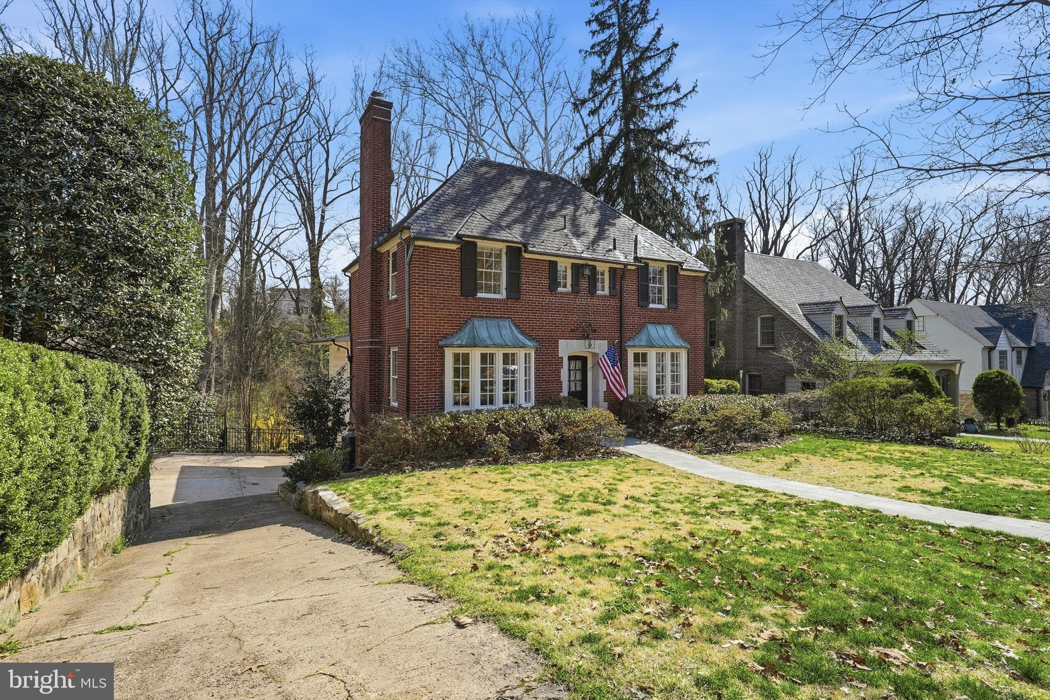 4938 Quebec Street Northwest Washington, DC 20016 - Photo 3 of 51 a front view of a house with a yard