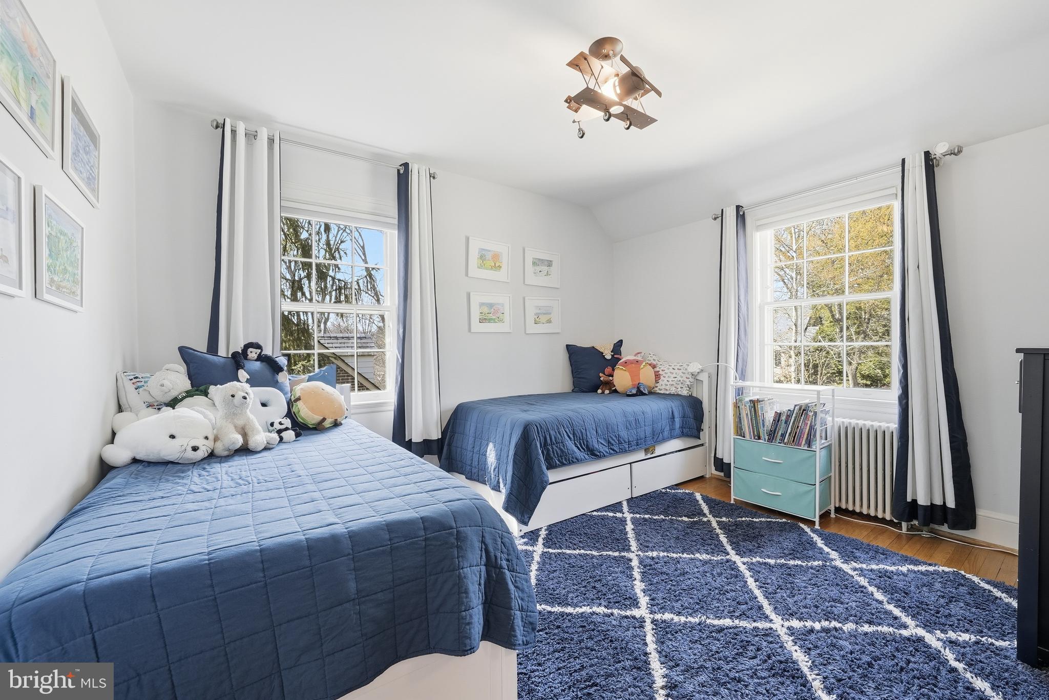 4938 Quebec Street Northwest Washington, DC 20016 - Photo 32 of 51 a bedroom with two beds and a window