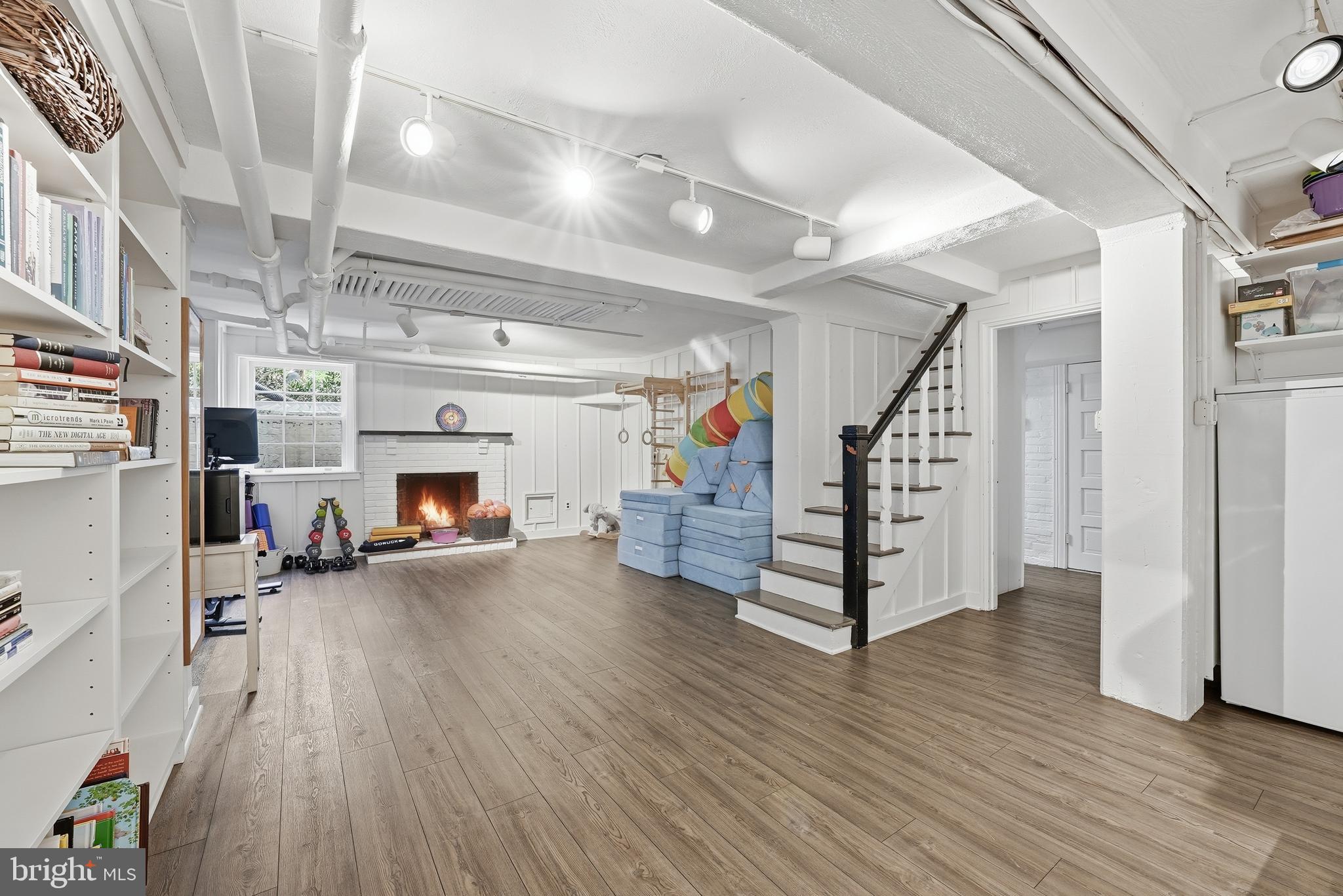 4938 Quebec Street Northwest Washington, DC 20016 - Photo 40 of 51 a view of a livingroom with wooden floor and furniture