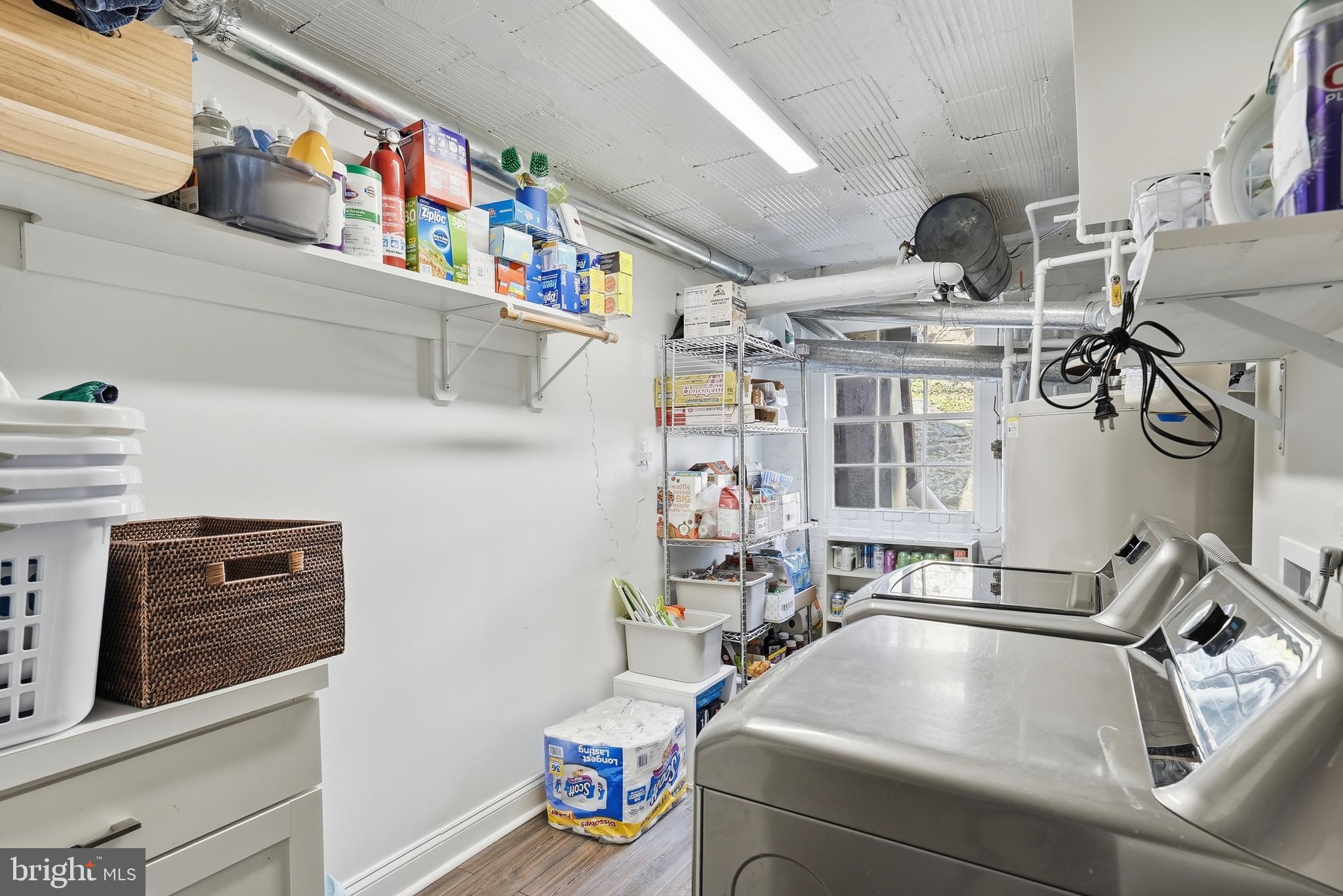 4938 Quebec Street Northwest Washington, DC 20016 - Photo 46 of 51 a utility room with dryer washer and a view of living room