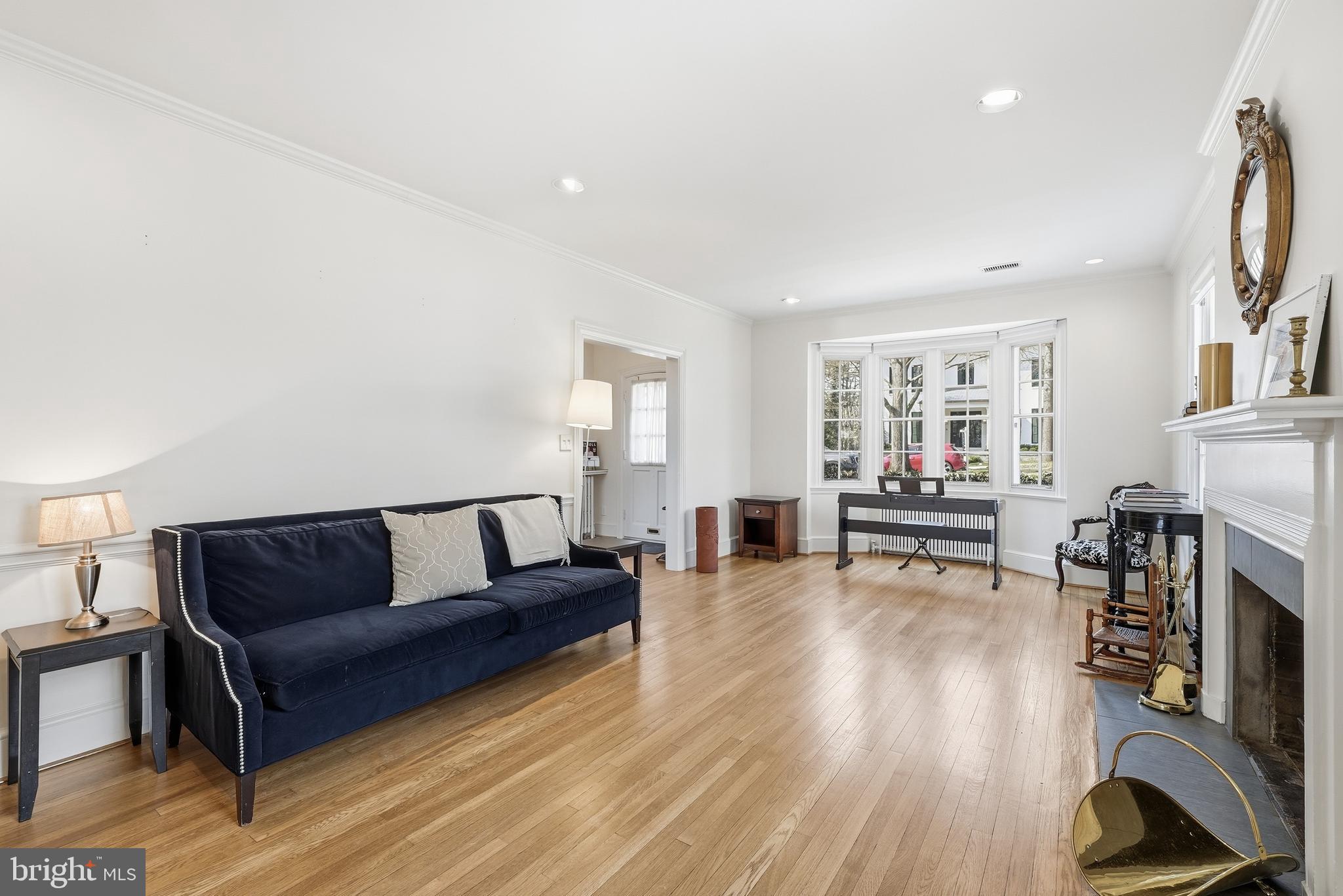4938 Quebec Street Northwest Washington, DC 20016 - Photo 8 of 51 a living room with furniture and a fireplace