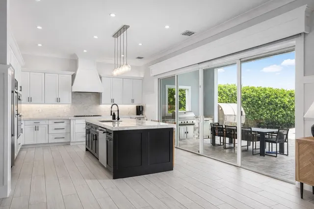 a en suite bathroom with a sink double vanity granite and a mirror