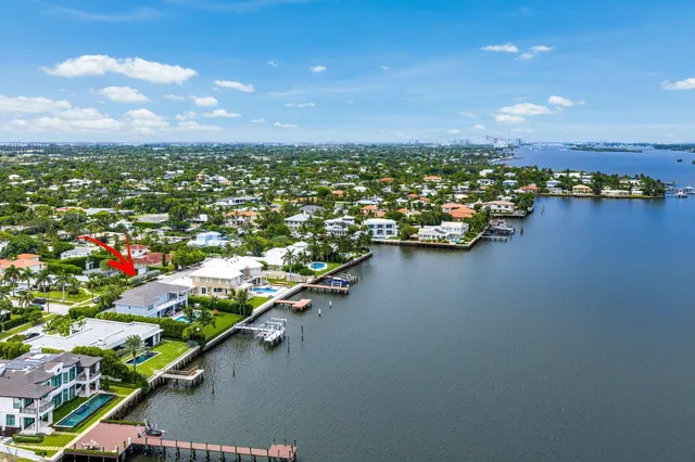 a living room with furniture ceiling fan and a large window
