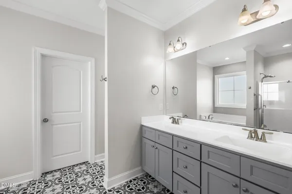 a spacious bathroom with double sink and a mirror