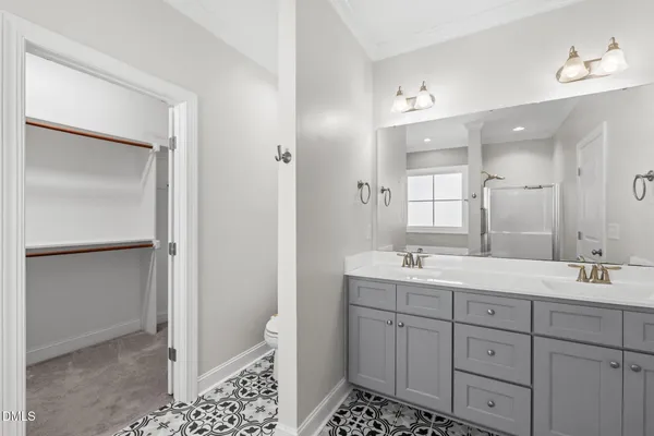 a bathroom with a double vanity sink a mirror and a shower