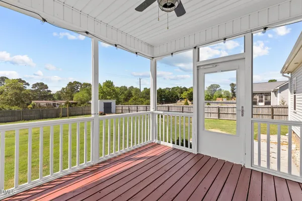 a view of balcony with wooden floor