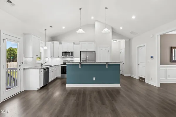 a view of kitchen with window and wooden floor