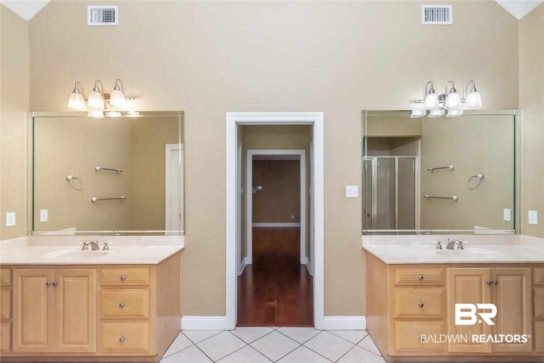 8837 Dawes Lake Road South Mobile, AL 36619 - Photo 18 of 44 Bathroom featuring vanity, lofted ceiling, hardwood / wood-style flooring, and a shower with door