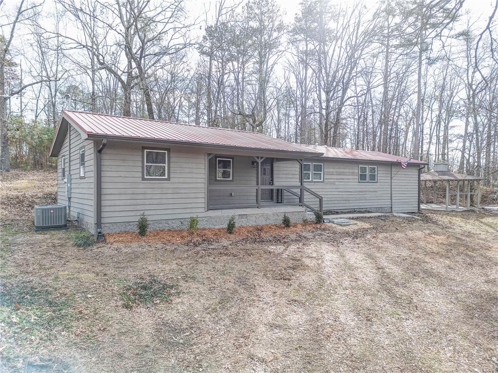 1388 Shope Lake Road Southeast Rydal, GA 30171 - Photo 1 of 1 a view of a house with a yard and garage