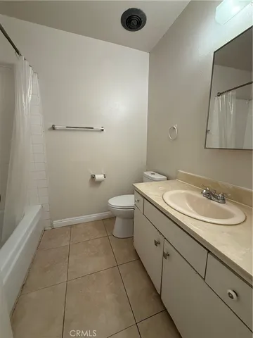 a bathroom with a granite countertop sink a toilet and a mirror