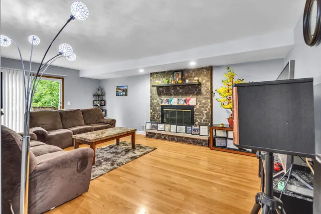 a living room with furniture a window and a flat screen tv