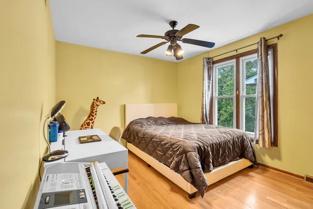 a bedroom with a bed and a large window