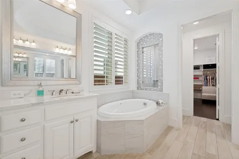a spacious bathroom with sinks mirror and a bathtub