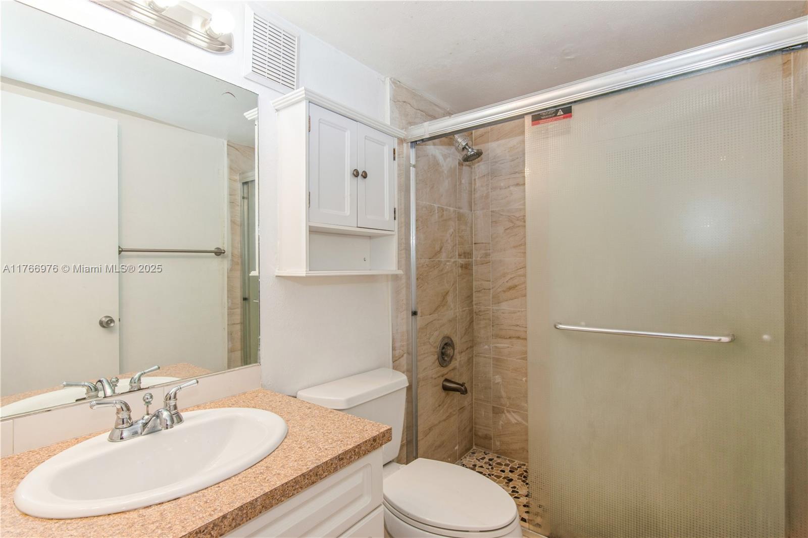 8200 Southwest 210th Street, Unit 111 Cutler Bay, FL 33189 - Photo 14 of 23 a bathroom with a sink toilet and shower